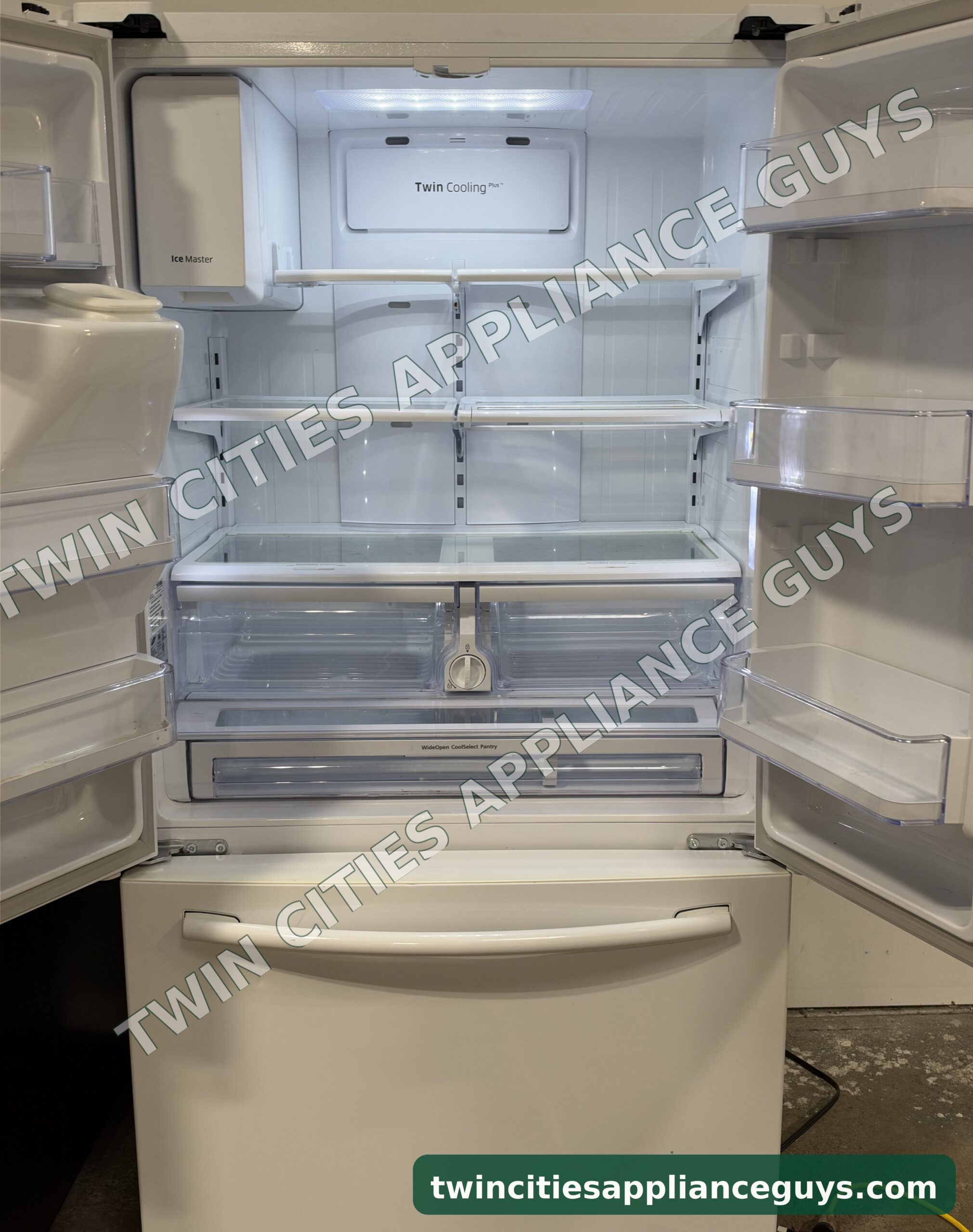 Samsung refrigerator with French doors open showing shelves and drawers