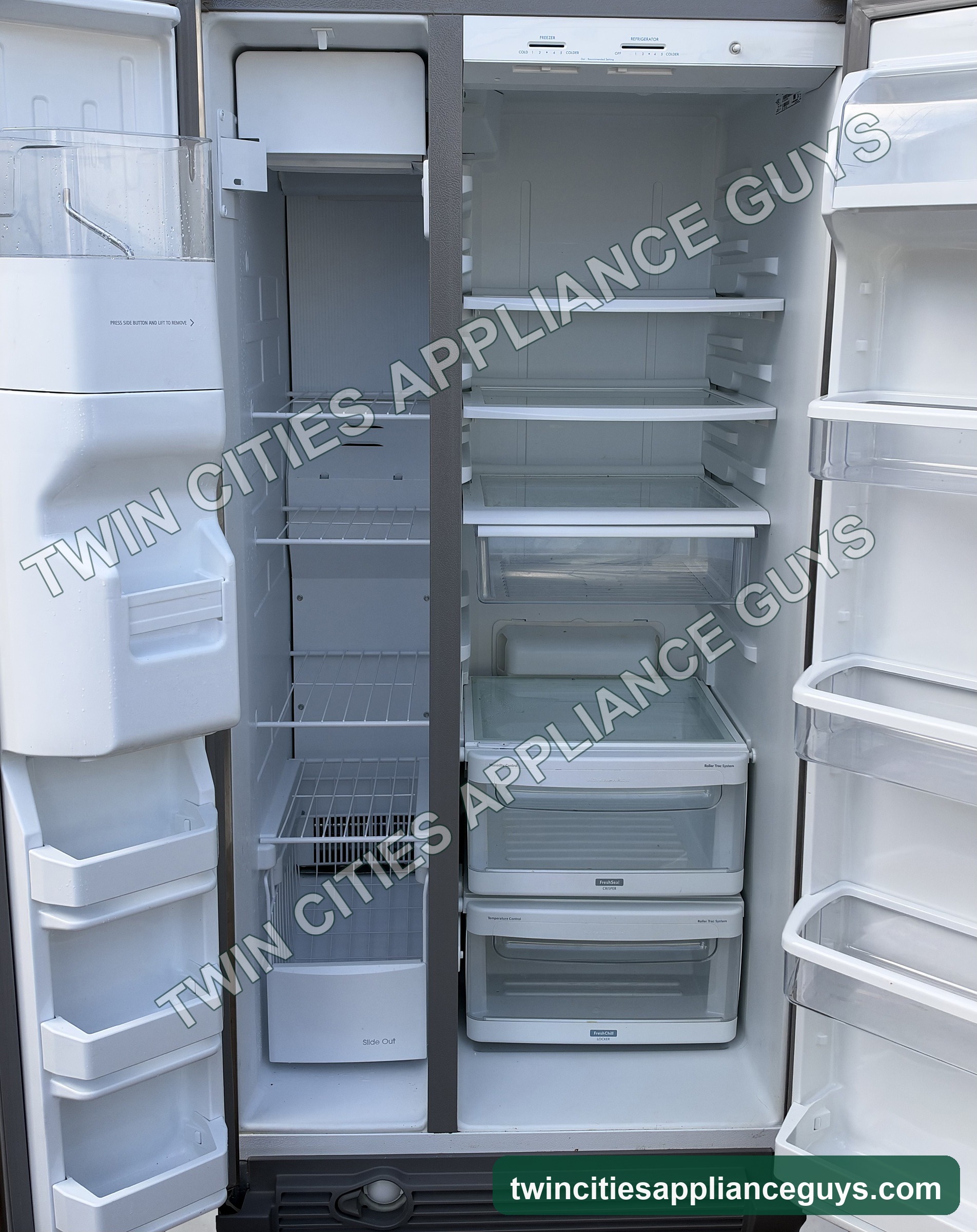 KitchenAid side-by-side refrigerator with both doors open showing freezer and fresh food shelves