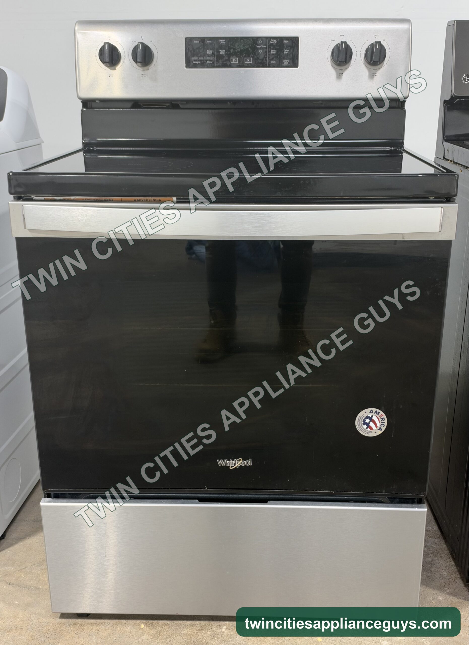 Stainless Whirlpool electric range front view with smoothtop cooktop and oven door closed