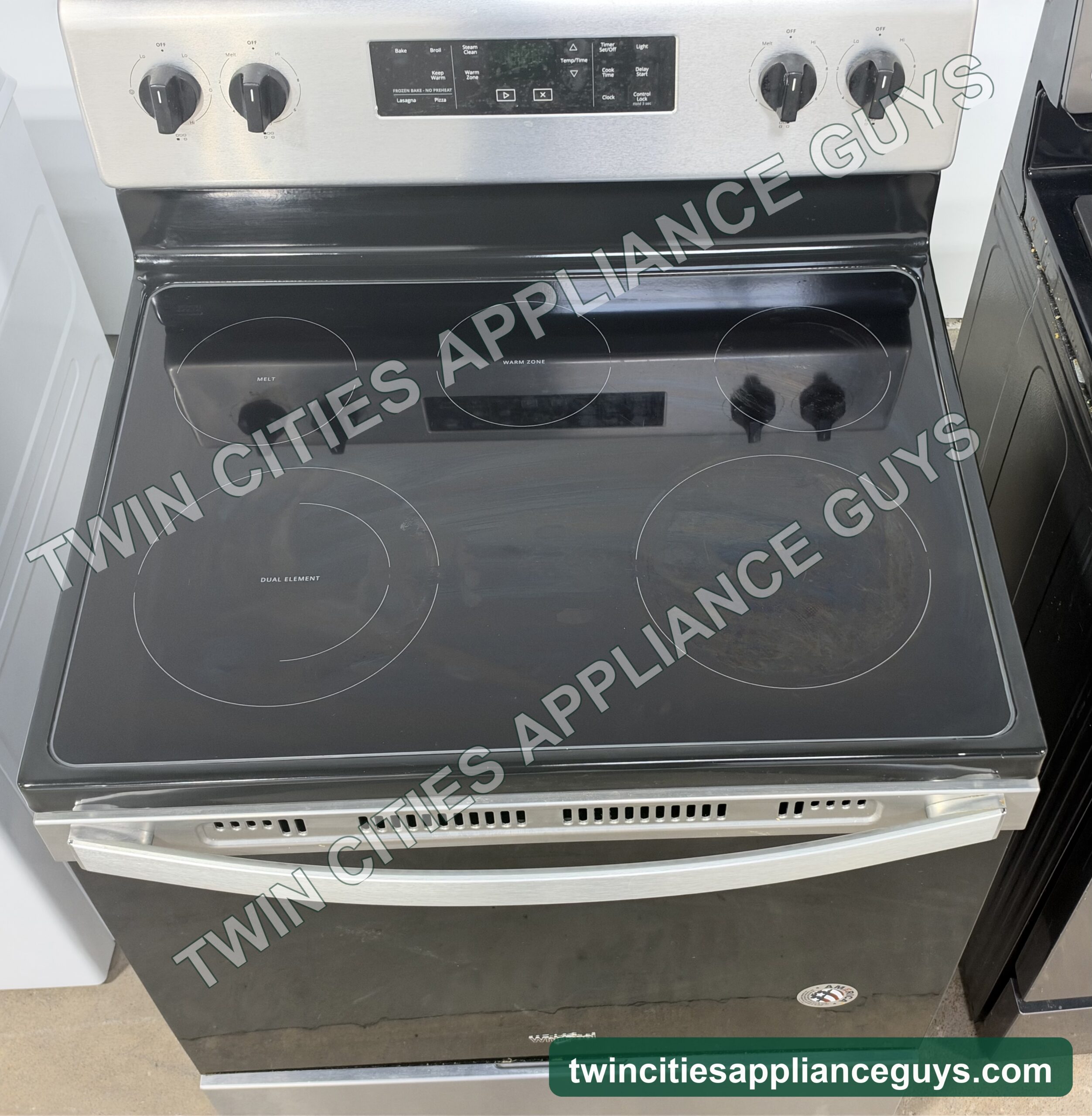 Whirlpool electric range smoothtop cooktop seen from above with control knobs