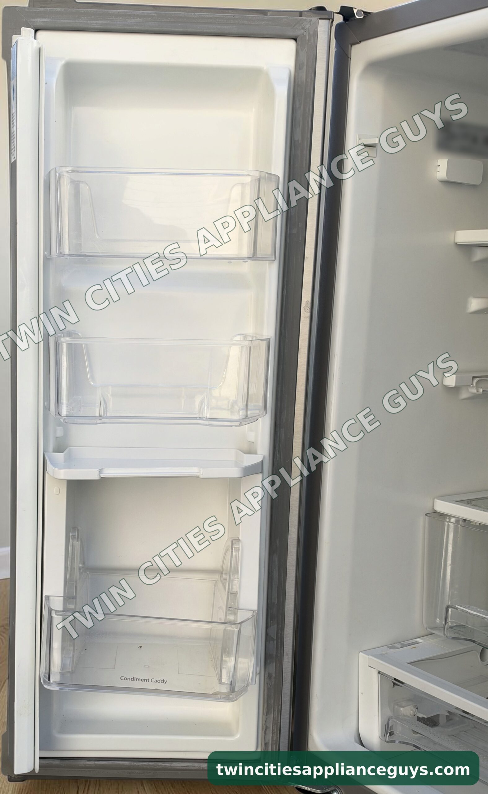 Whirlpool refrigerator left door open showing door bins and condiment caddy