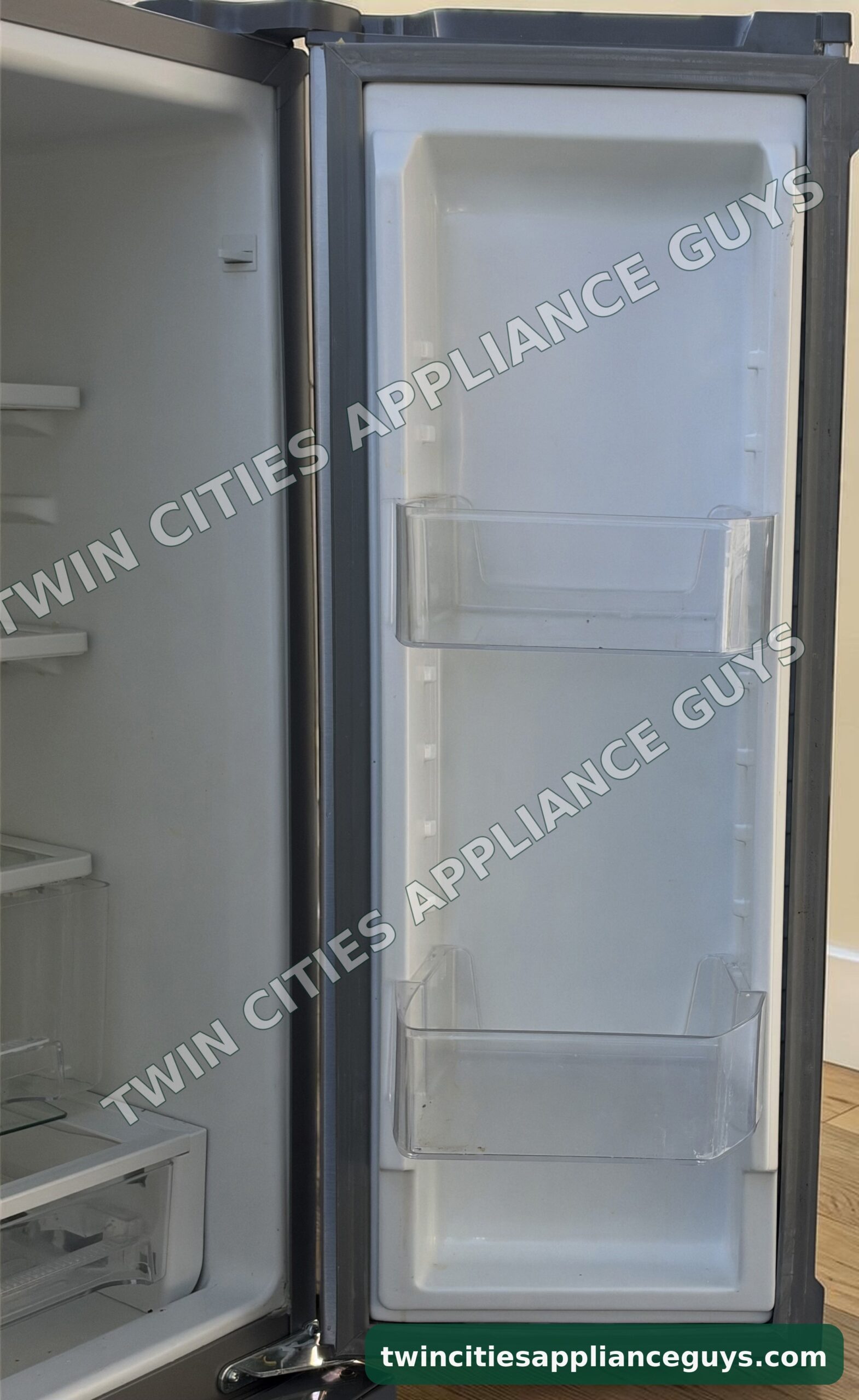 Whirlpool refrigerator right door open showing door bins beside the fresh food section