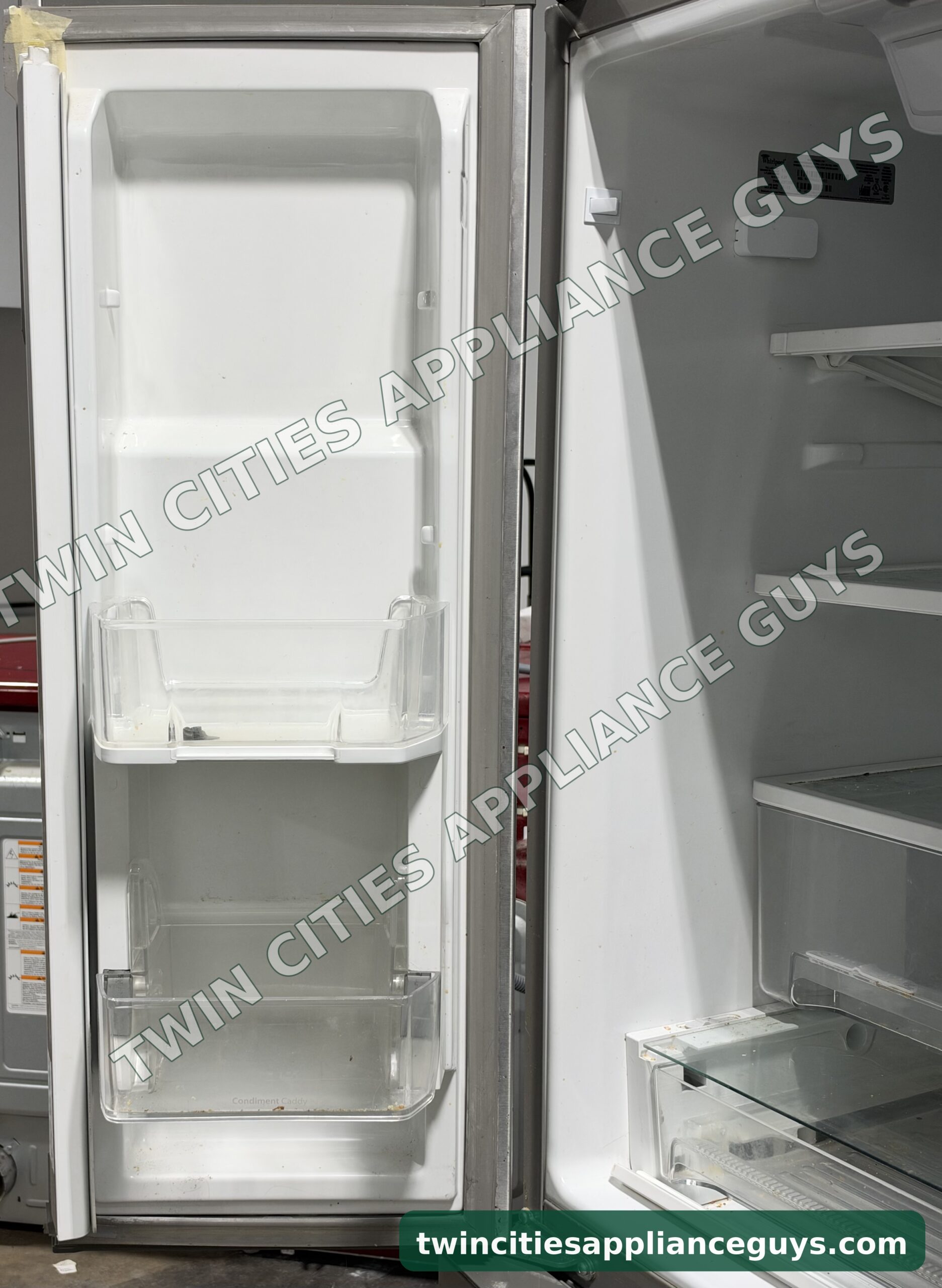 Whirlpool refrigerator left door open showing the door bins