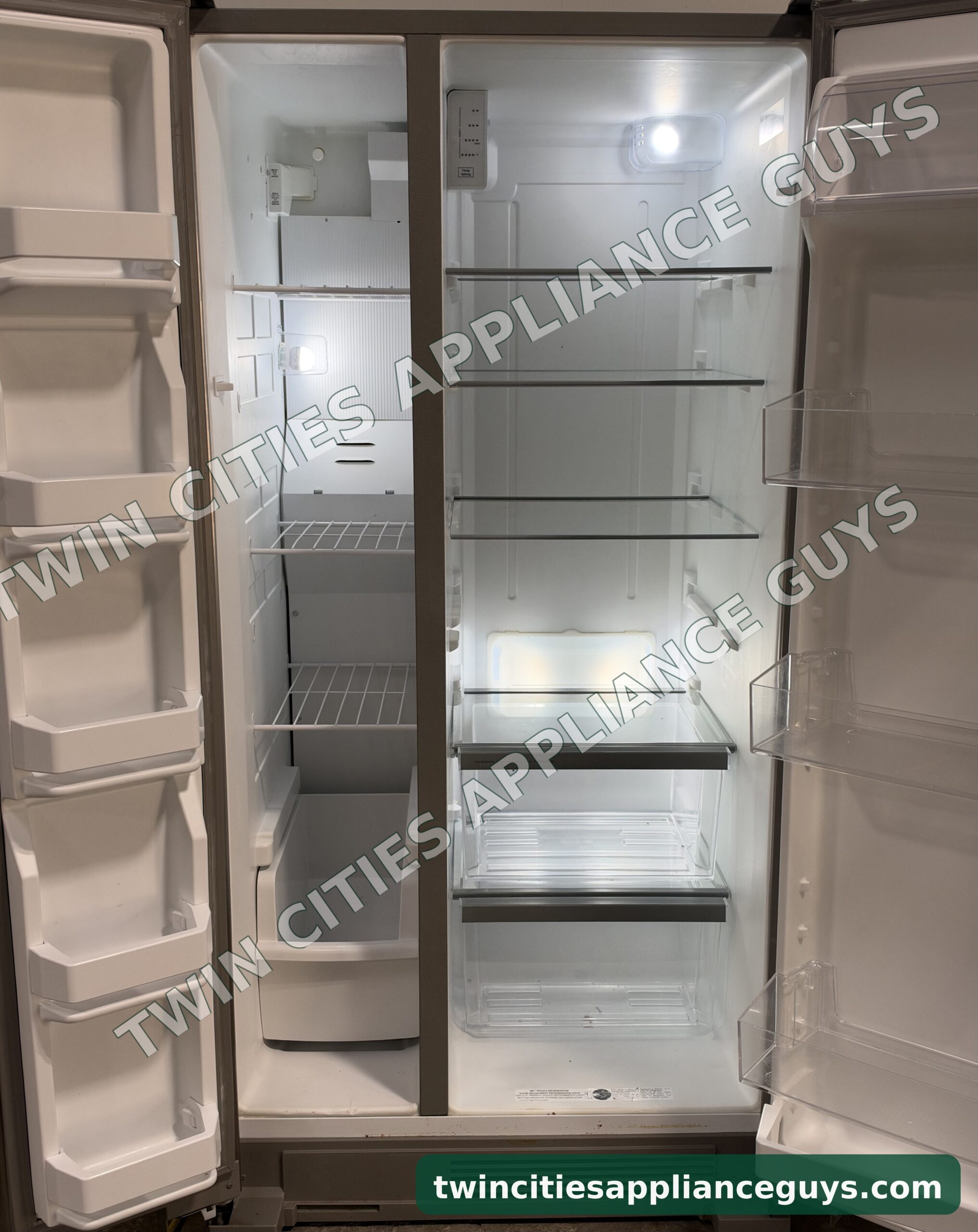 Whirlpool side-by-side refrigerator with both doors open showing shelves, crisper drawers and door bins