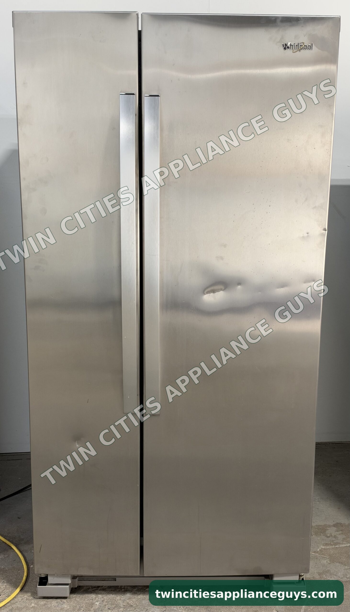 Stainless Whirlpool side-by-side refrigerator front view with both doors closed